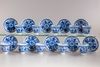 A group of eleven blue and white saucers and ten cups