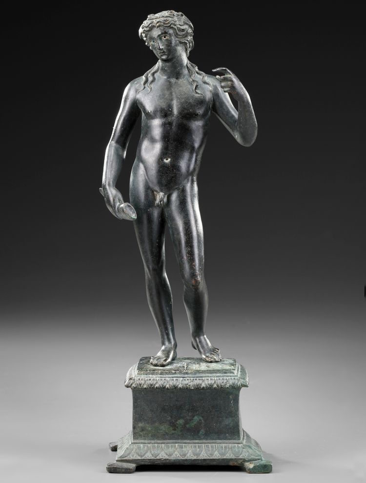 A ROMAN BRONZE STATUETTE OF APOLLO CARNEUS, CIRCA 1ST-2ND CENTURY A.D.