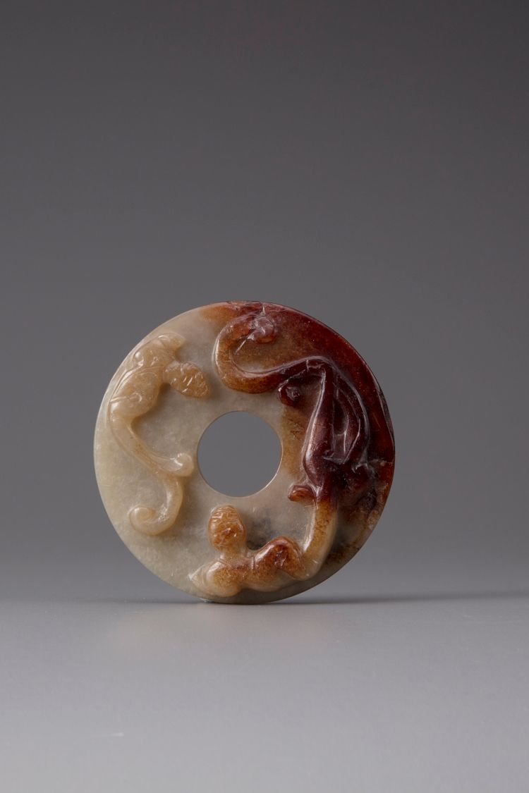 A pale celadon and russet jade bi disc