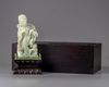 A pale jade carving of a guanyin in a zitan box and stand