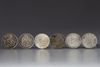 Five Chinese silver coins and a silver Mexican peso