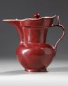 A CHINESE RUBY-RED GLAZED MONK'S CAP EWER