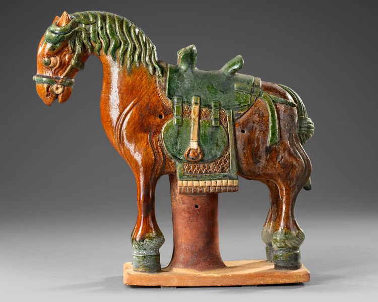 A CHINESE GREEN AND BROWN  GLAZED HORSE, MING DYNASTY (1368-1644 AD)