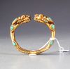 A SINO TIBETAN GILDED BANGLE, 19TH CENTURY