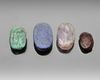 A GROUP OF FOUR HARD STONE SCARABS, CIRCA 1500-500 B.C.