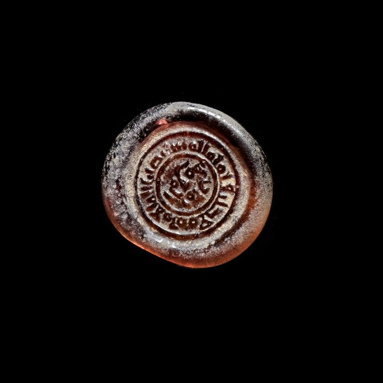 AN EARLY ISLAMIC GLASS WEIGHT OF DIRHAM