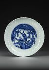 A CHINESE BLUE AND WHITE INCISED DECORATED DISH, WANLI PERIOD (1573-1619)