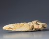 An ivory carving of a reclining Guanyin holding a ruyi sceptre