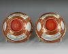 A pair of Chinese coral-ground famille rose 'Tilling and Weaving' bowls