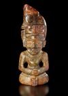 A RUSSET JADE SITTING FIGURE WEARING A PIG DRAGON ON IT'S HEAD, CHIN, HONGSHAN CULTURE