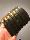 A Chinese Hongshan-style spinach and russet jade comb-shaped accessory