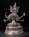 A SINO-TIBETAN BRONZE FIGURE OF THREE-HEADED SEATED BODHISATTVA