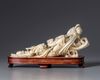 An ivory carving of a reclining Guanyin holding a ruyi sceptre