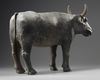 A RARE CHINESE PAINTED POTTERY FIGURE OF AN OX, HAN DYNASTY (206 BC-220 AD)