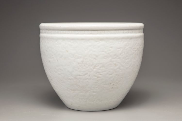 A white-glazed 'lotus' jardiniere