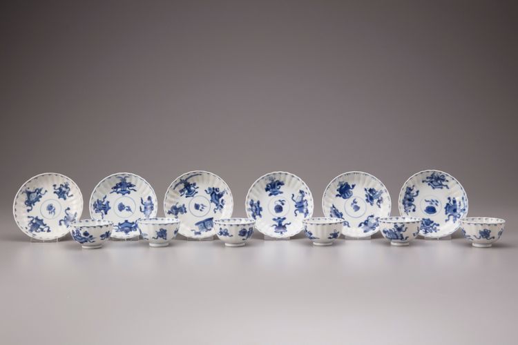 Six blue and white cups and saucers