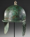 A ROMAN MONTEFORTINO BRONZE HELMET, CIRCA 1ST CENTURY B.C. / A.D.