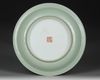 A CHINESE FAMILLE ROSE CELADON-GROUND DISH, 19TH-20TH CENTURY