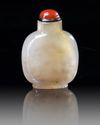 A CHINESE SHADOW AGATE 'BUDDHIST LION' SNUFF BOTTLE