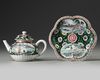 A CHINESE BLACK-GROUND FAMILLE ROSE TEAPOT, COVER AND STAND, YONGZHENG PERIOD (1723-1735)