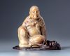 A Chinese soapstone  figure with a zitan wooden stand