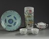 A Chinese famille rose hatstand, a famille rose three-piece tea set, and a celadon-ground blue and white dish