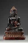 A Large Bronze Buddha Sitting on a Lotus