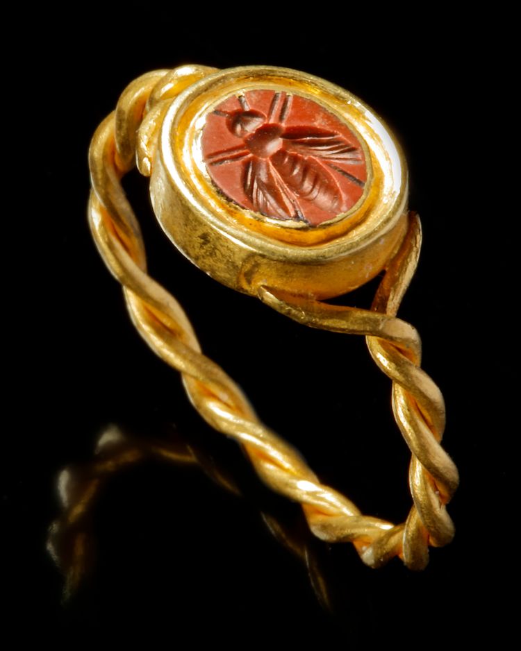 A ROMAN RED JASPER INTAGLIO OF A BEE WITH GOLD RING, CIRCA 1ST-2ND CENTURY A.D.