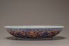 An iron-red decorated blue and white 'dragon' dish