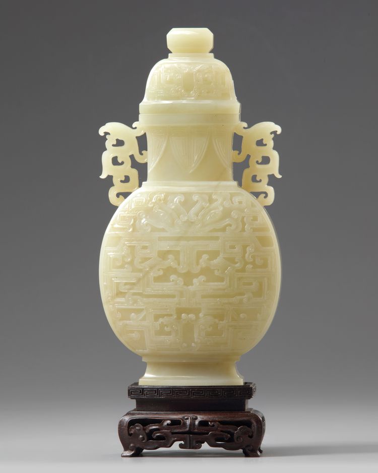 A Chinese pale celadon jade 'taotie' vase and cover