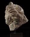 A ROMAN BASALT HEAD OF A WOMAN "HAURAN", CIRCA 2ND CENTURY A.D.
