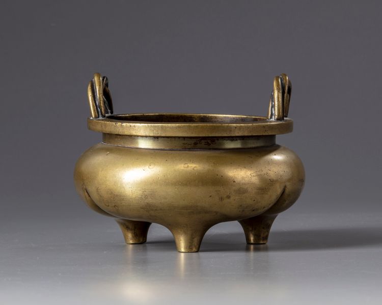 A gilt Chinese bronze tripod