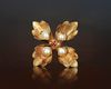 A 14 CARAT GOLD FOLIATE SHAPED BROOCH ADORNED WITH PEARLS