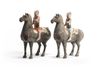 A pair of Chinese painted grey pottery figures of equestrians