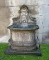 A CONTINENTAL SCULPTED LIMESTONE WALLFOUNTAIN, 20TH CENTURY