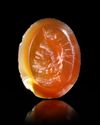 A ROMAN CARNELIAN INTAGLIO WITH A BUST OF SERAPIS, 1ST-2ND CENTURY AD