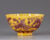 A CHINESE YELLOW-GROUND AUBERGINE-DECORATED 'DRAGON AND PHOENIX' BOWL