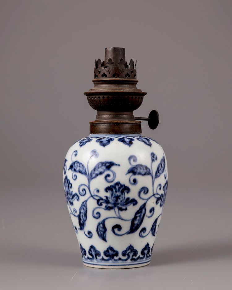 A Chinese blue and white jar with a copper oil lamp cover