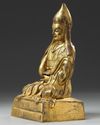 A Chinese gilt bronze figure of a Lama