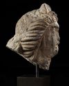 A ROMAN BASALT HEAD OF A WOMAN "HAURAN", CIRCA 2ND CENTURY A.D.