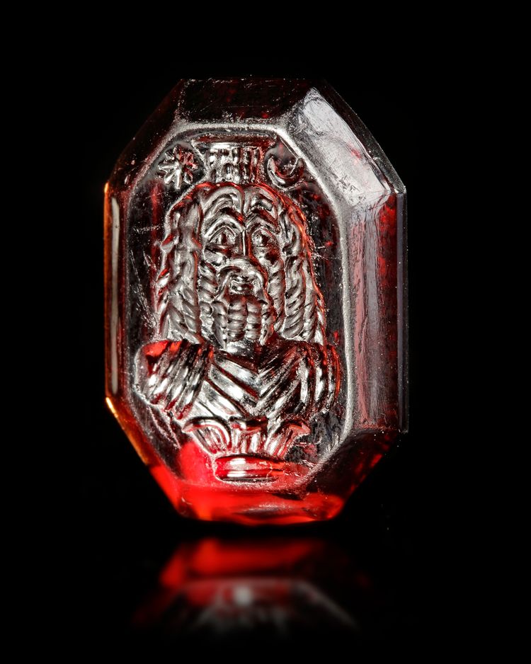 A ROMAN GARNET INTAGLIO OF SERAPIS, 1ST-2ND CENTURY AD