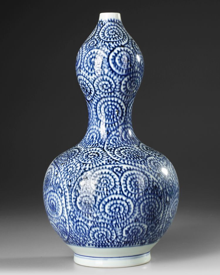 A JAPANESE BLUE AND WHITE  DOUBLE- GOURD SAKE VASE, WITH OCTOPUS AND KARAKUSA, LATE EDO PERIOD, 18TH CENTURY