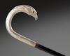 A SILVER-MOUNTED BLACK WOOD WALKING CANE WITH BIRD-HEAD HANDLE