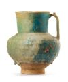 AN IRIDESCENT TURQUOISE BLUE GLAZED POTTERY JUG, KASHAN, 12TH CENTURY