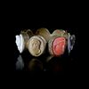 A LATE GEORGIAN GRAND TOUR GILT METAL LAVA, CORAL CAMEO RING, 19TH CENTURY