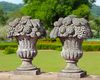 A PAIR OF LIMESTONE PIER FINIALS IN THE FORM OF FLOWER/FRUIT BASKETS, 20TH CENTURY