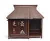 A Japanese wooden stand for tea utensils in the shape of a thatched tea house