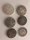 Five Chinese silver coins and a silver Mexican peso