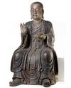 A CHINESE POLYCHROME-DECORATED WOOD LUOHAN, LATE MING DYNASTY, 17TH CENTURY