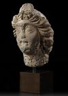 A ROMAN BASALT HEAD OF A WOMAN "HAURAN", CIRCA 2ND CENTURY A.D.